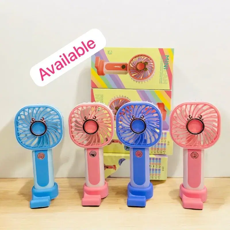 portable mini handheld fan featuring a built-in mobile phone holder base and a cute decorative design.